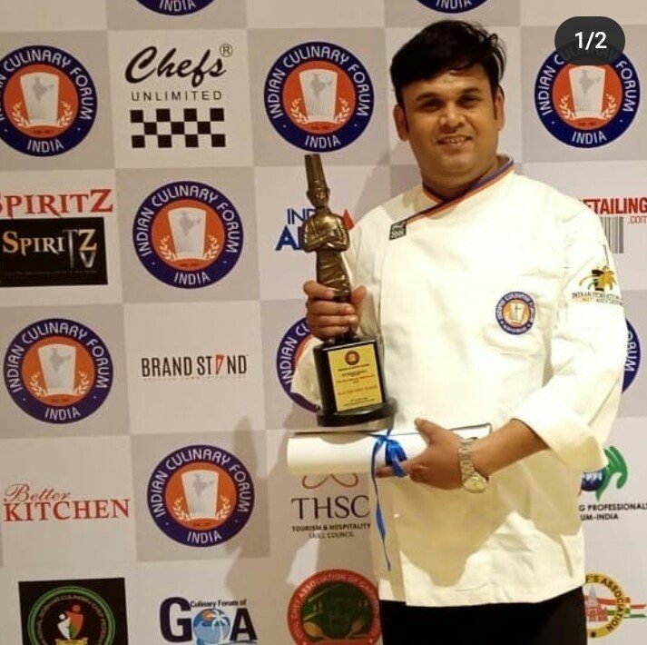 Narendra Singh holding a trophy at a culinary event